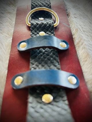 Solo Sally Casual Kink Cuffs. Solo, uno, single, one cuff. Thick red cuff, black strap and blue accents